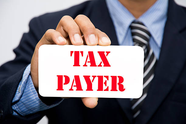 Businessman hand holding TAX PAYER concept